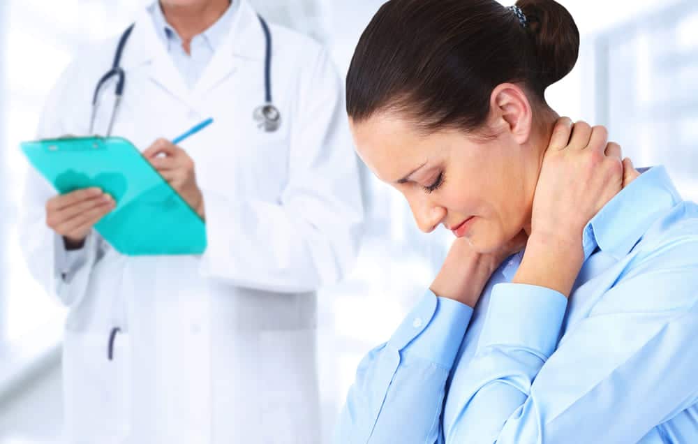 Spine Surgeon Examines the lady with Chronic Neck Pain
